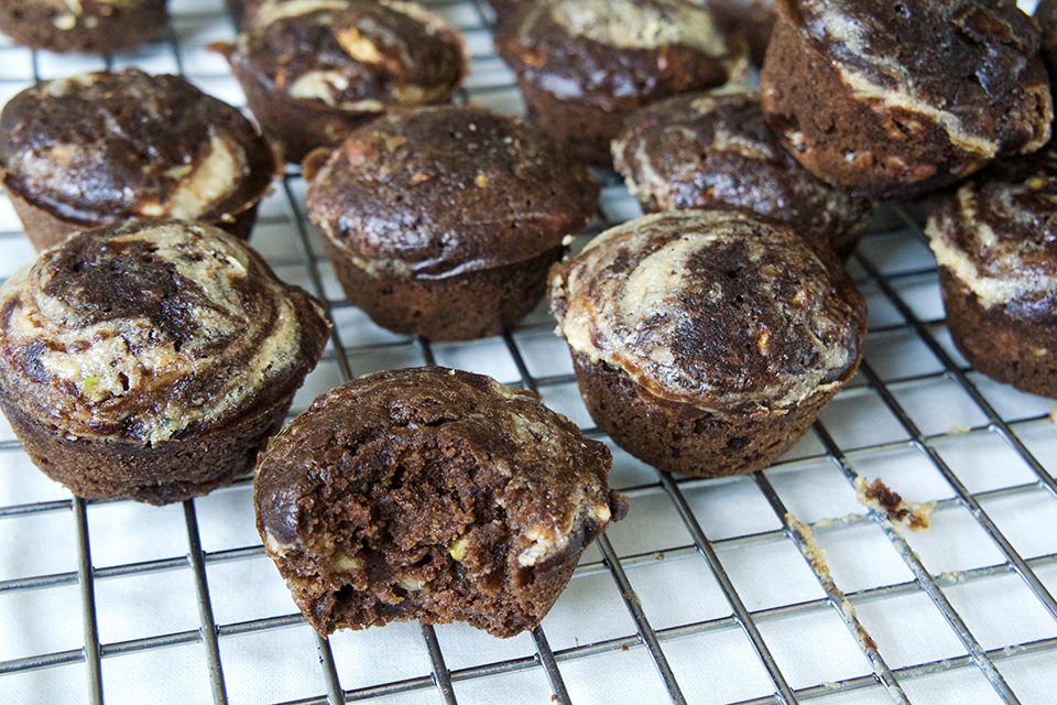 Bite out of a chocolate zucchini tahini swirl Muffin